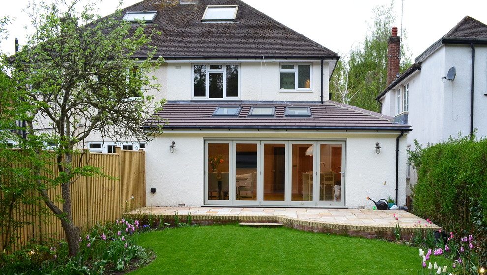 Photo of a medium sized and white contemporary two floor brick house exterior in Hertfordshire with a hip roof.