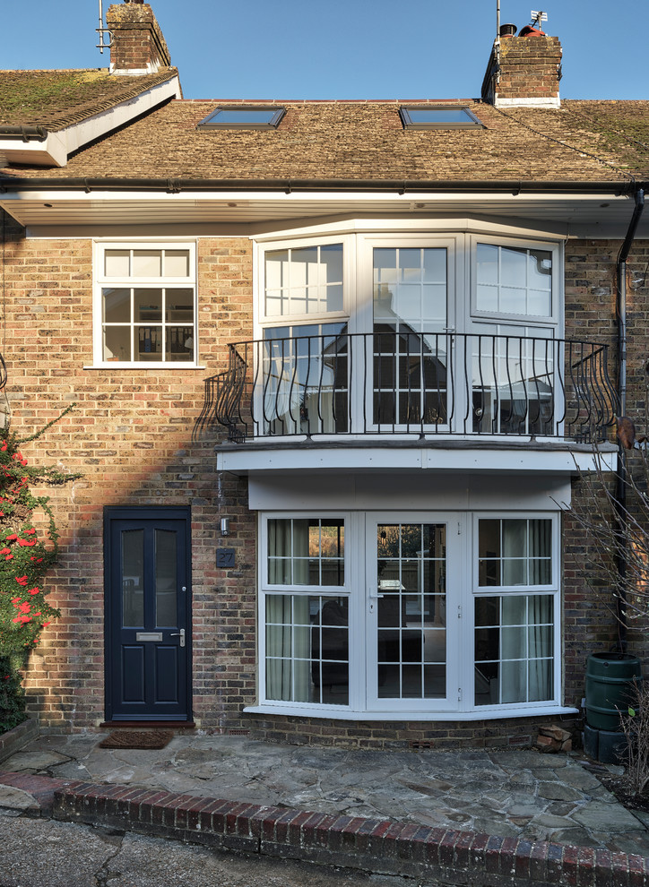 Inspiration for a small modern brick terraced house in Sussex with three floors, a pitched roof and a tiled roof.