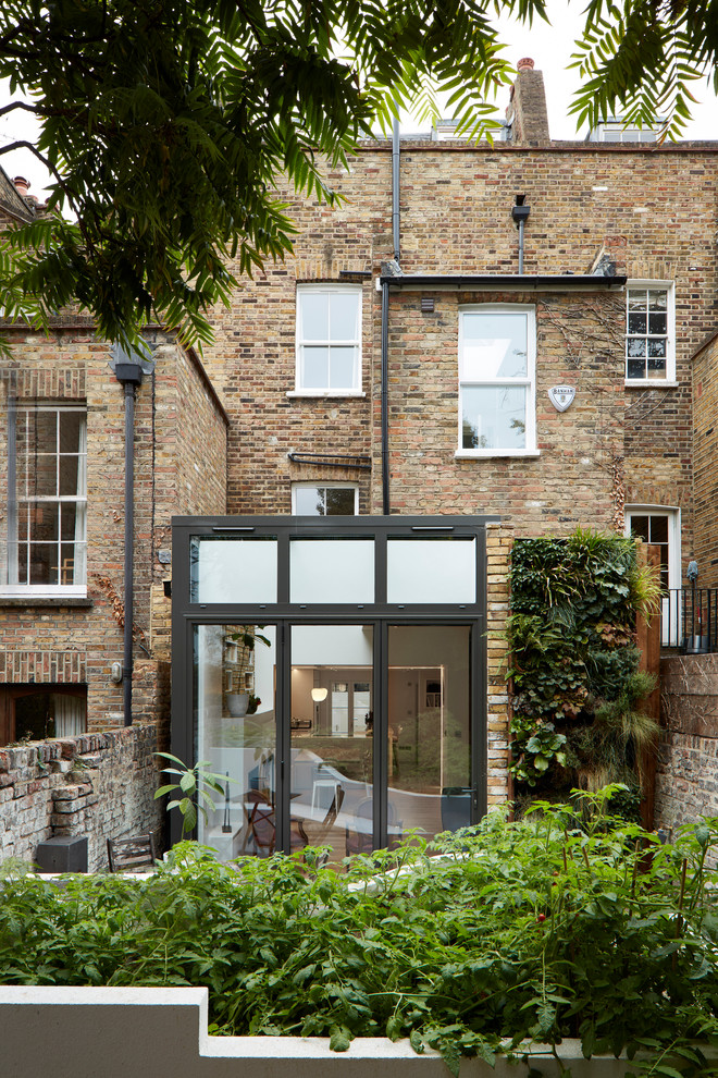 Inspiration for a contemporary house exterior in London with three floors.