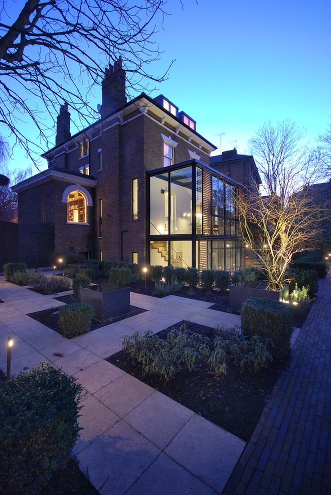 Inspiration for a large contemporary three-story brick exterior home remodel in London