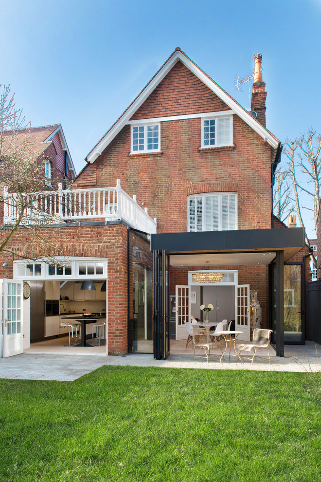 This is an example of a traditional brick and rear house exterior in London with three floors and a pitched roof.