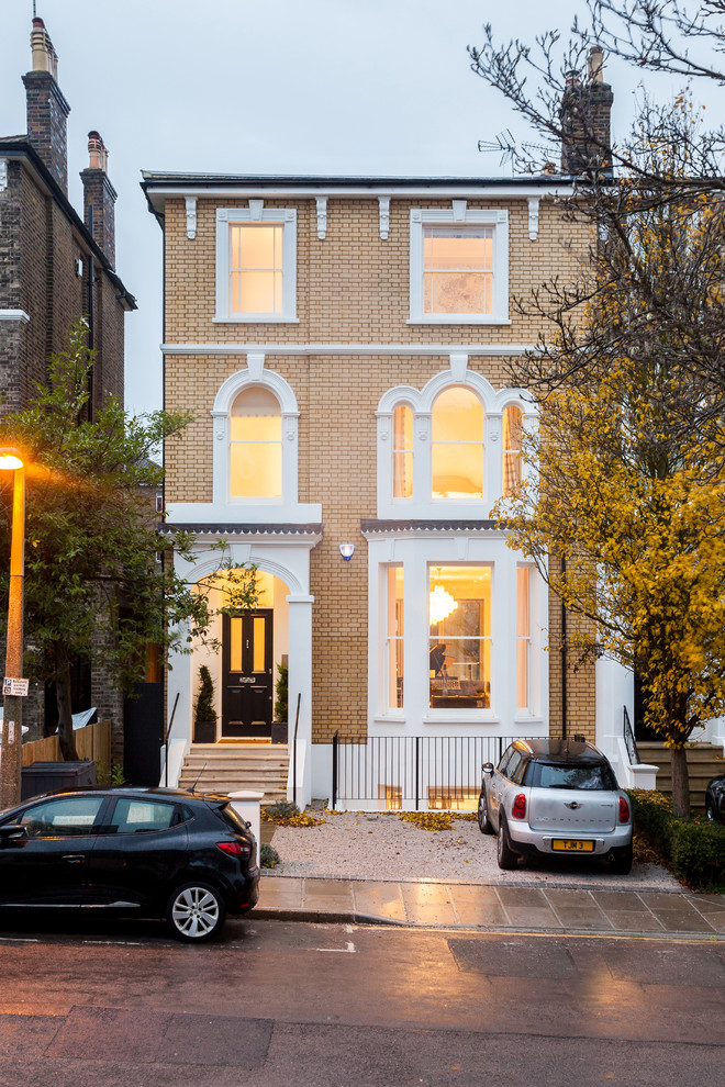 Inspiration for a mid-sized timeless three-story brick townhouse exterior remodel in London