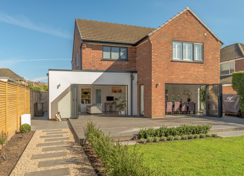 Photo of a contemporary two floor brick house exterior in Cheshire with a pitched roof.