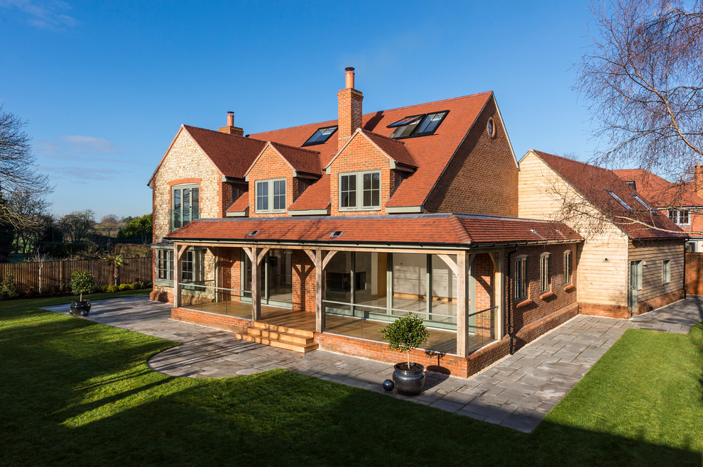 Inspiration for an expansive and multi-coloured contemporary detached house in Hampshire with three floors, wood cladding, a pitched roof and a tiled roof.