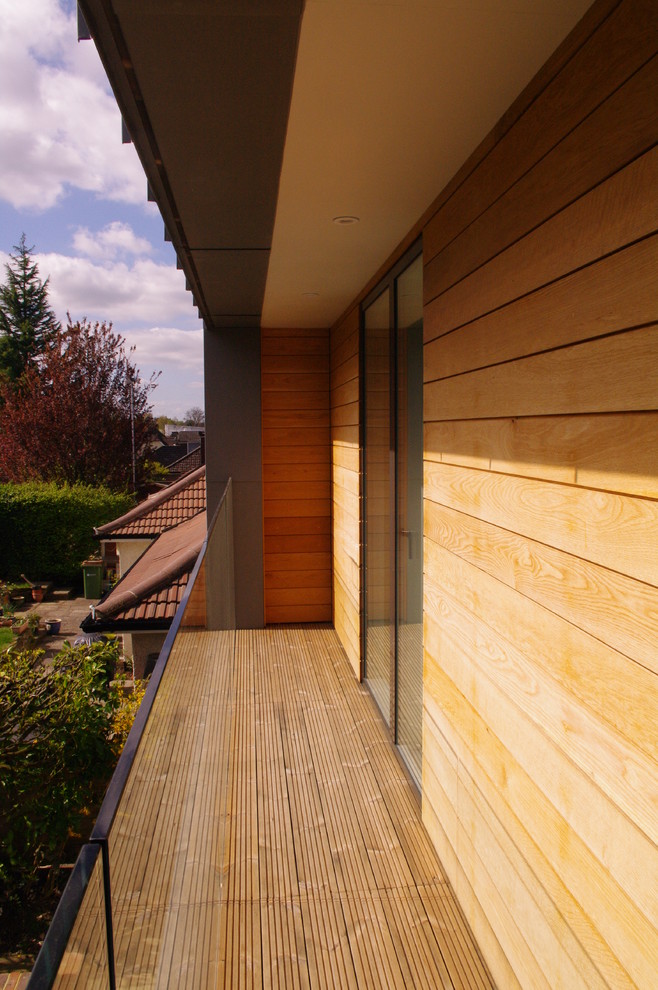 Example of a small minimalist two-story exterior home design in Surrey