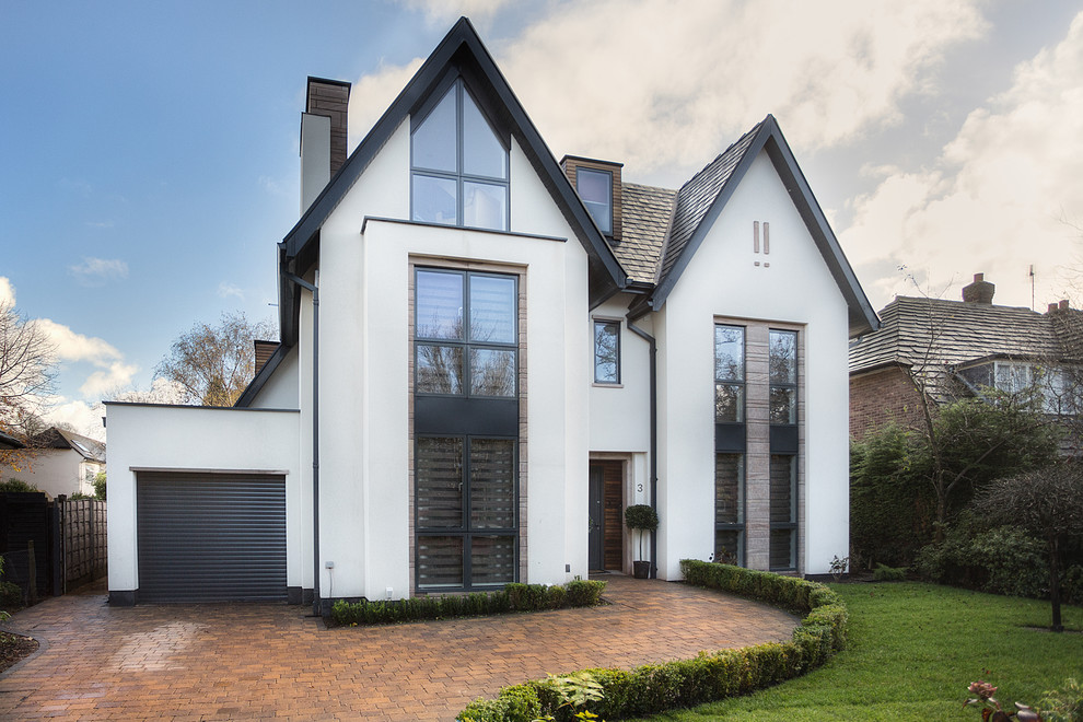 Large and white contemporary house exterior in Cheshire with three floors, mixed cladding and a pitched roof.