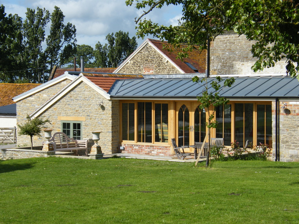 Design ideas for a rural house exterior in Dorset with stone cladding.