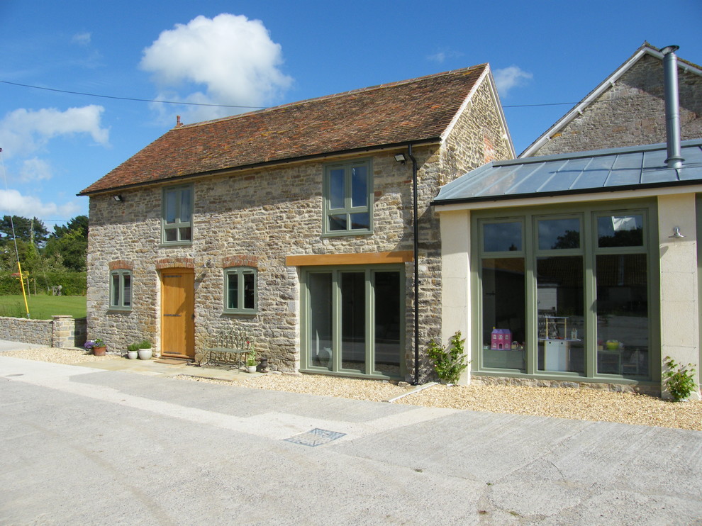 Inspiration for a farmhouse stone exterior home remodel in Dorset