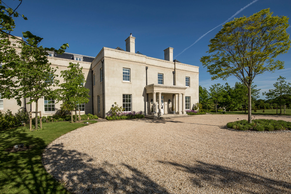Expansive and white traditional render house exterior in Hampshire with three floors and a mansard roof.