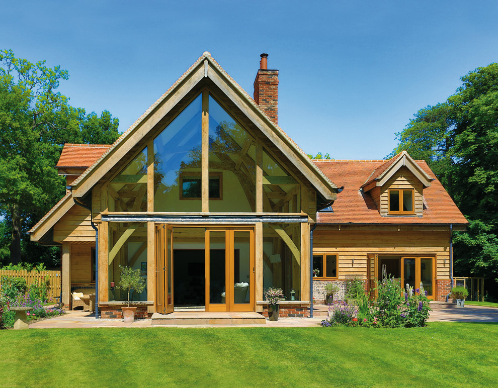 Example of a large trendy two-story wood exterior home design in Wiltshire