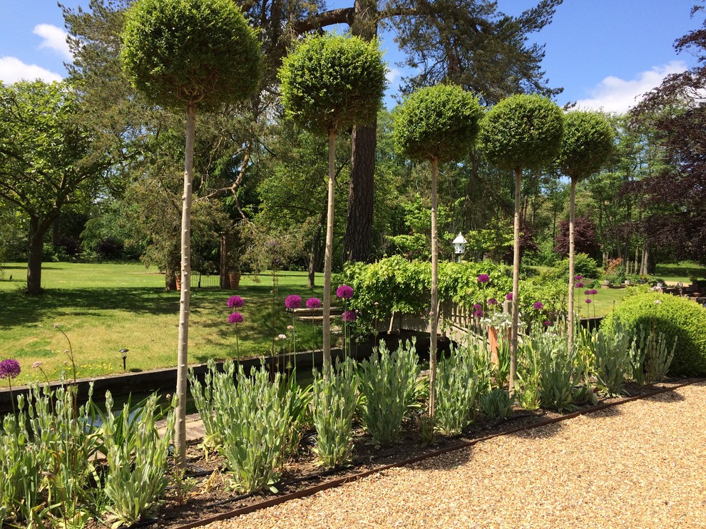 Idee per un ampio giardino formale contemporaneo esposto in pieno sole dietro casa in estate con ghiaia