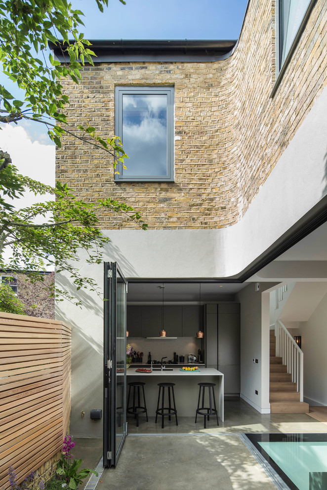This is an example of a contemporary house exterior in London with mixed cladding.