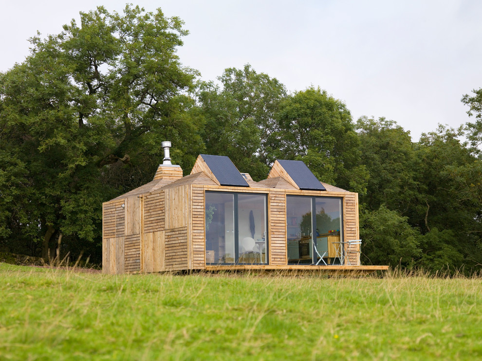 Small mountain style one-story wood tiny house photo in Other