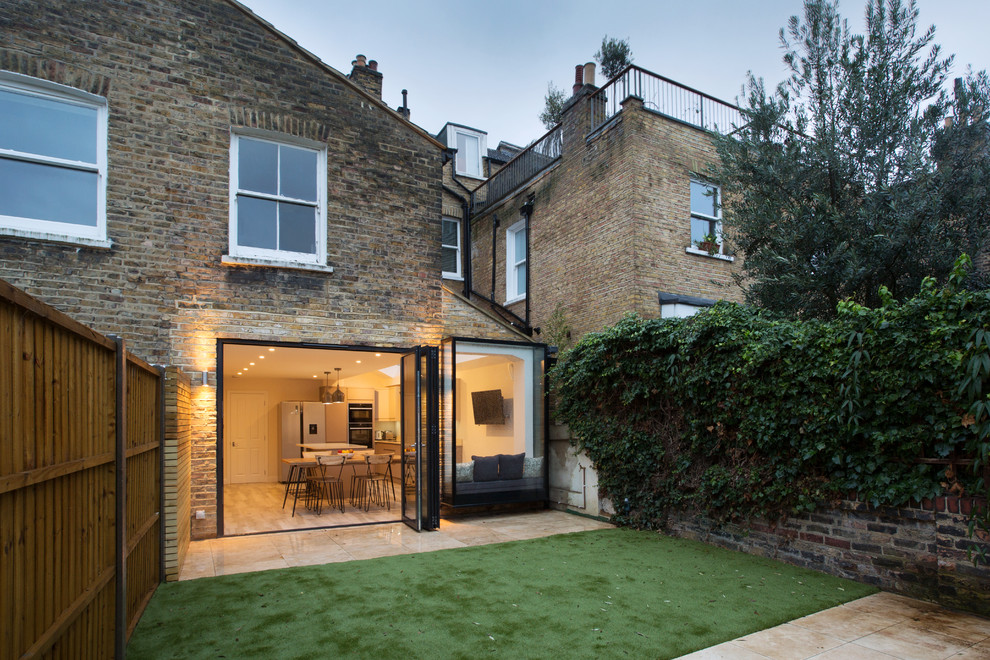 Inspiration for a large and brown contemporary brick terraced house in London with three floors, a pitched roof and a tiled roof.