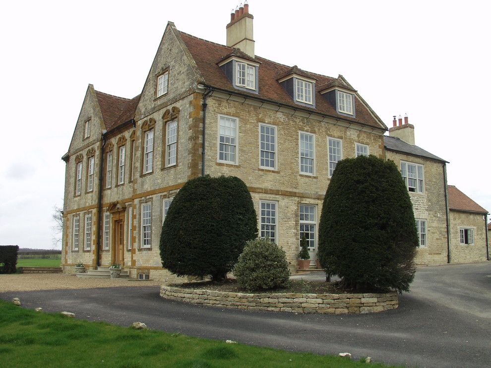Design ideas for a large classic house exterior in Oxfordshire with three floors and stone cladding.