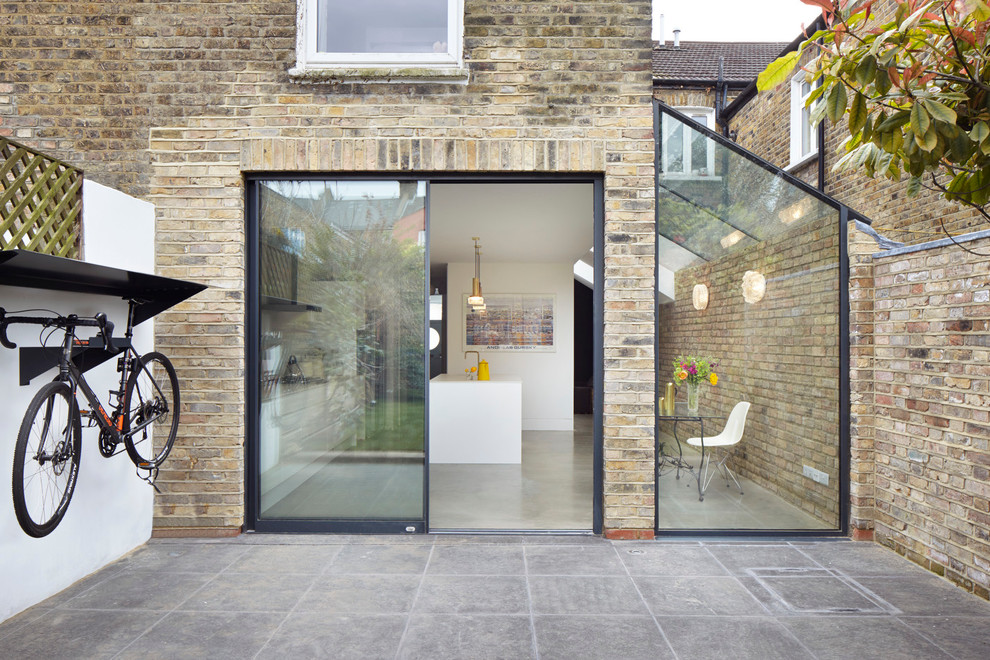 Design ideas for a small and white contemporary two floor brick house exterior in London with a pitched roof.