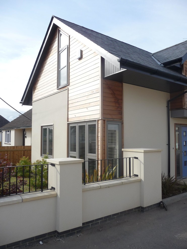 Large contemporary two floor house exterior in Hampshire with wood cladding.