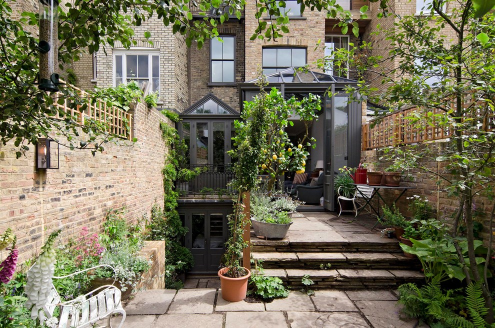 Photo of a large classic brick terraced house in London with three floors.