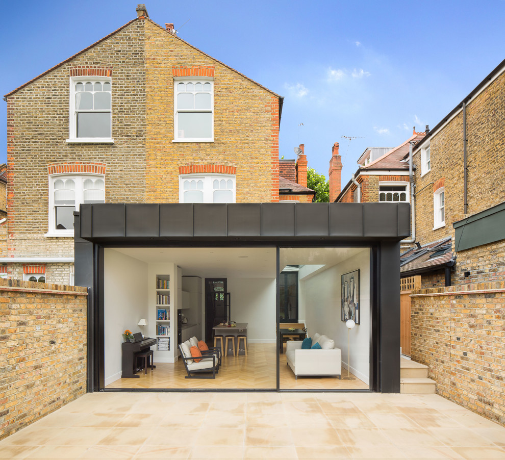 Medium sized and beige contemporary semi-detached house in London with three floors and mixed cladding.
