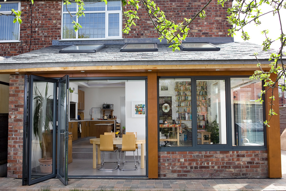 Inspiration for a contemporary brick house exterior in Manchester.