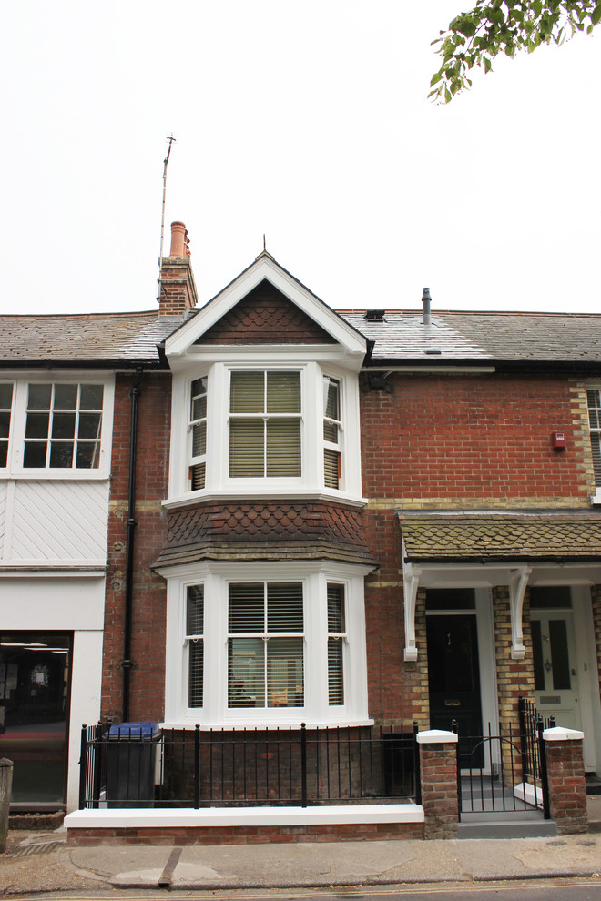Design ideas for a medium sized and red victorian brick house exterior in Kent with three floors.