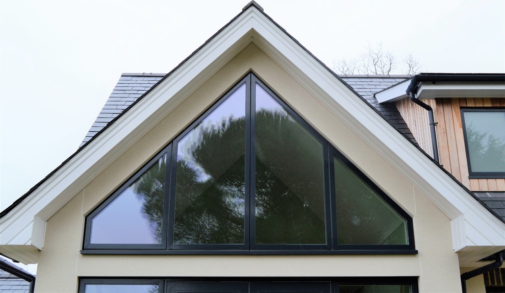 Photo of a contemporary two floor detached house in Sussex with mixed cladding.
