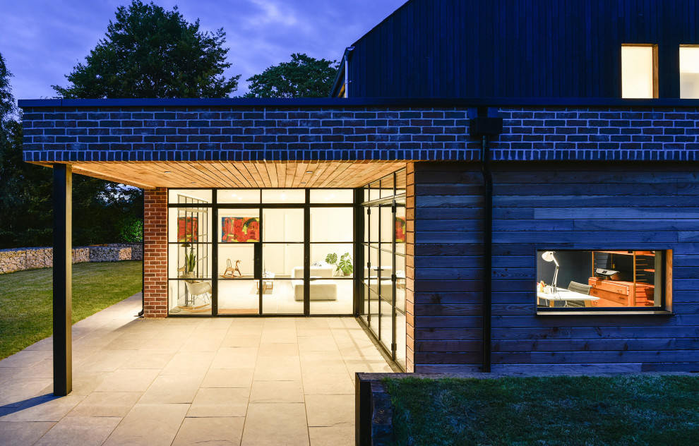Trendy two-story wood exterior home photo in Gloucestershire