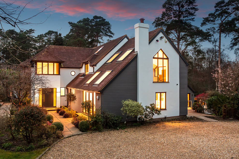 Inspiration for a white classic two floor detached house in Hampshire with mixed cladding and a hip roof.