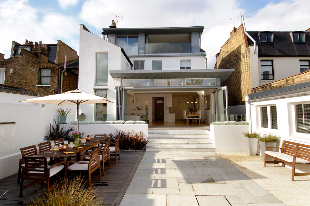 White contemporary house exterior in London with three floors.