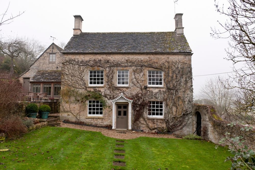 Example of a large farmhouse brown brick exterior home design in London