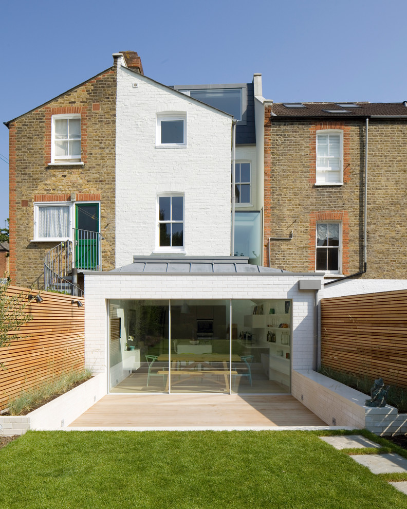 Photo of a contemporary house exterior in London with mixed cladding and a pitched roof.