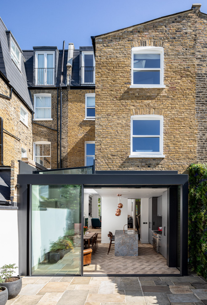 Inspiration for a medium sized contemporary brick terraced house in London with three floors, a mansard roof and a grey roof.