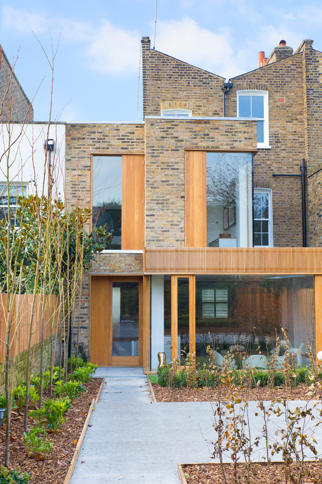 Contemporary brick house exterior in London with three floors.