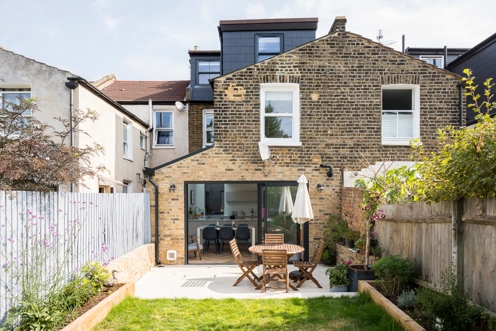 Inspiration for a brown contemporary brick detached house in London with three floors and a pitched roof.