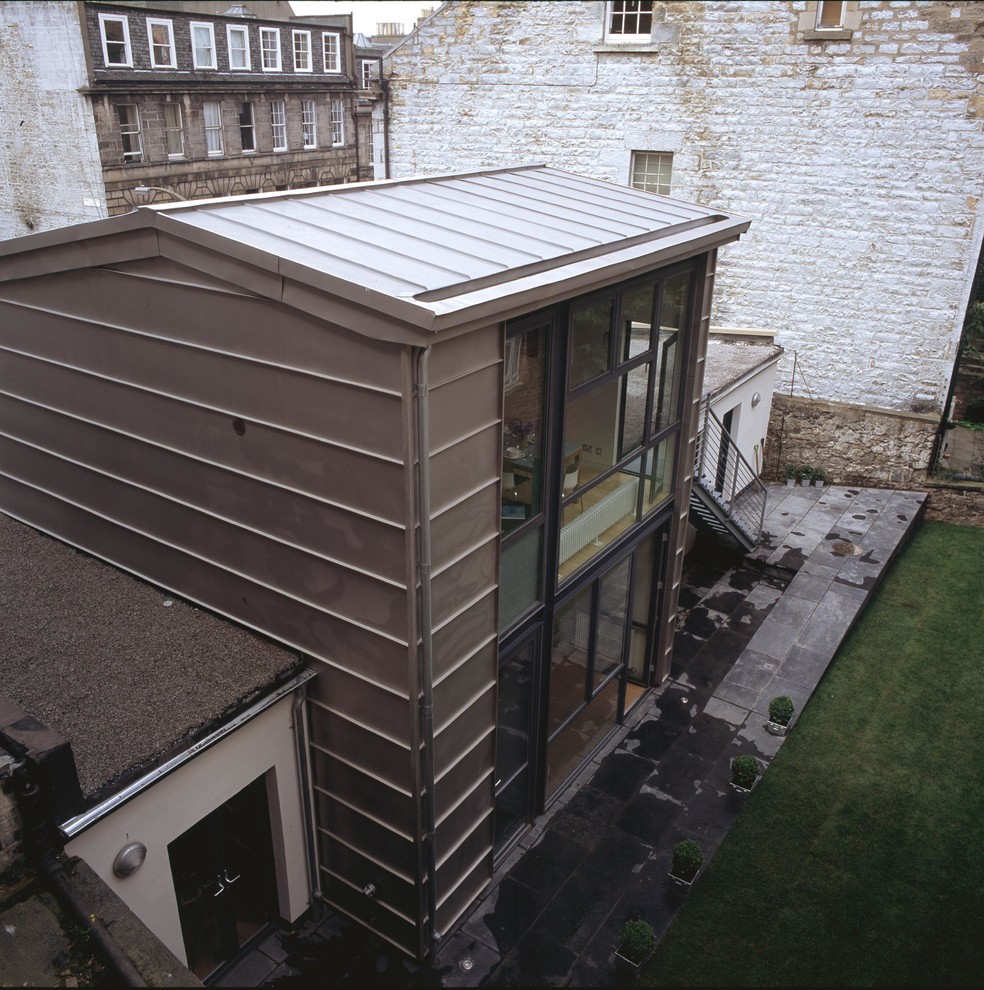 This is an example of a small contemporary two floor house exterior in Edinburgh with metal cladding.