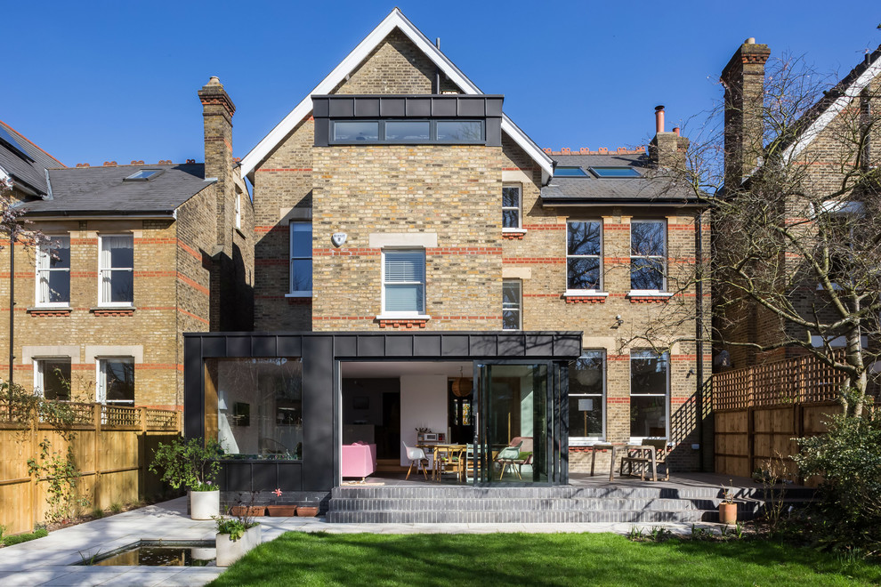 Inspiration for an expansive modern detached house in London with three floors, metal cladding and a hip roof.