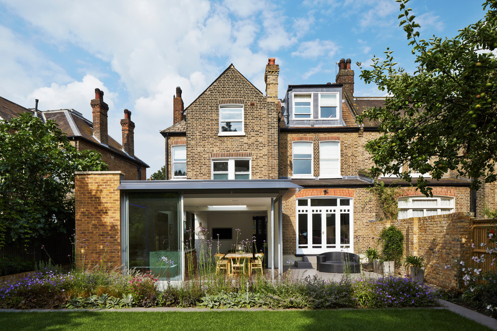 This is an example of a traditional brick and rear extension in London with three floors and a pitched roof.