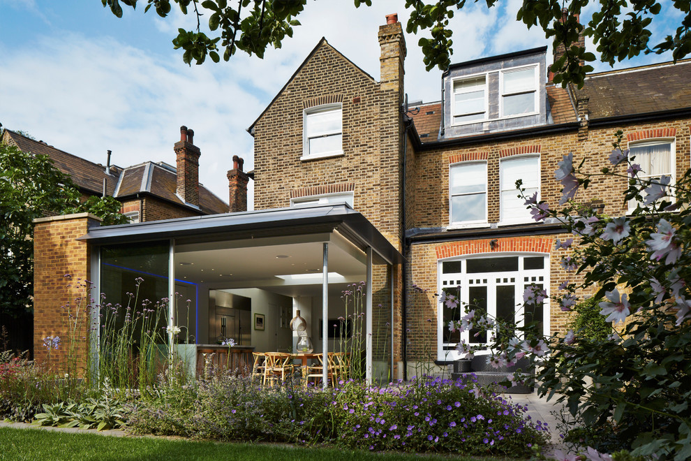 Design ideas for a classic brick and rear extension in London with three floors and a pitched roof.
