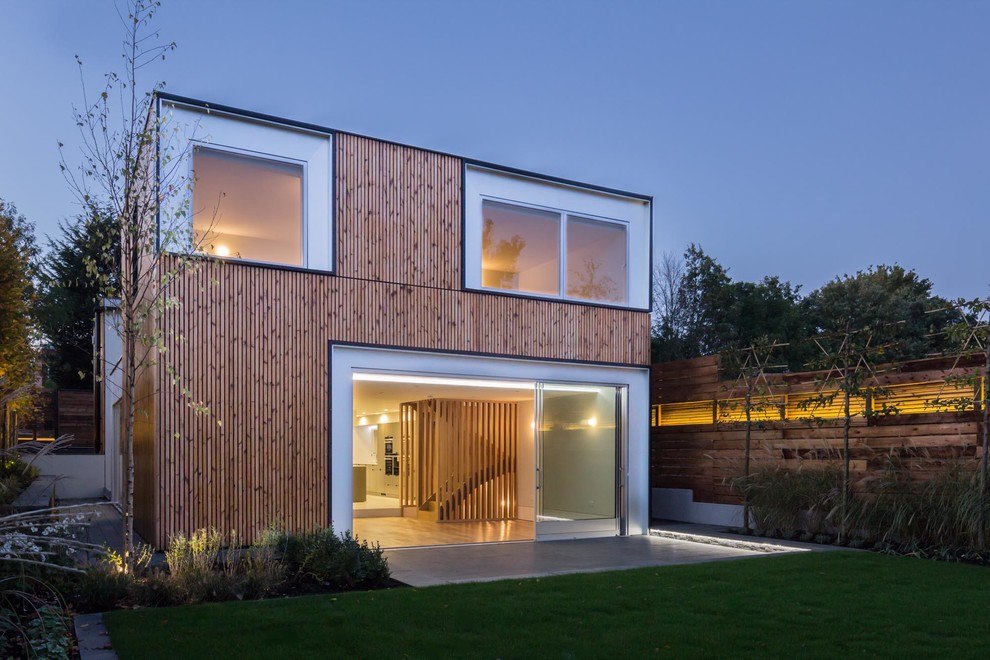 Photo of a contemporary two floor house exterior in London with wood cladding and a flat roof.