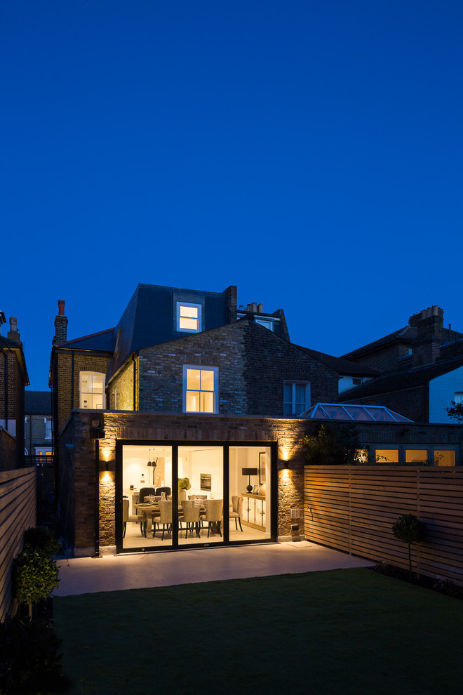 Medium sized contemporary brick house exterior in London with three floors.
