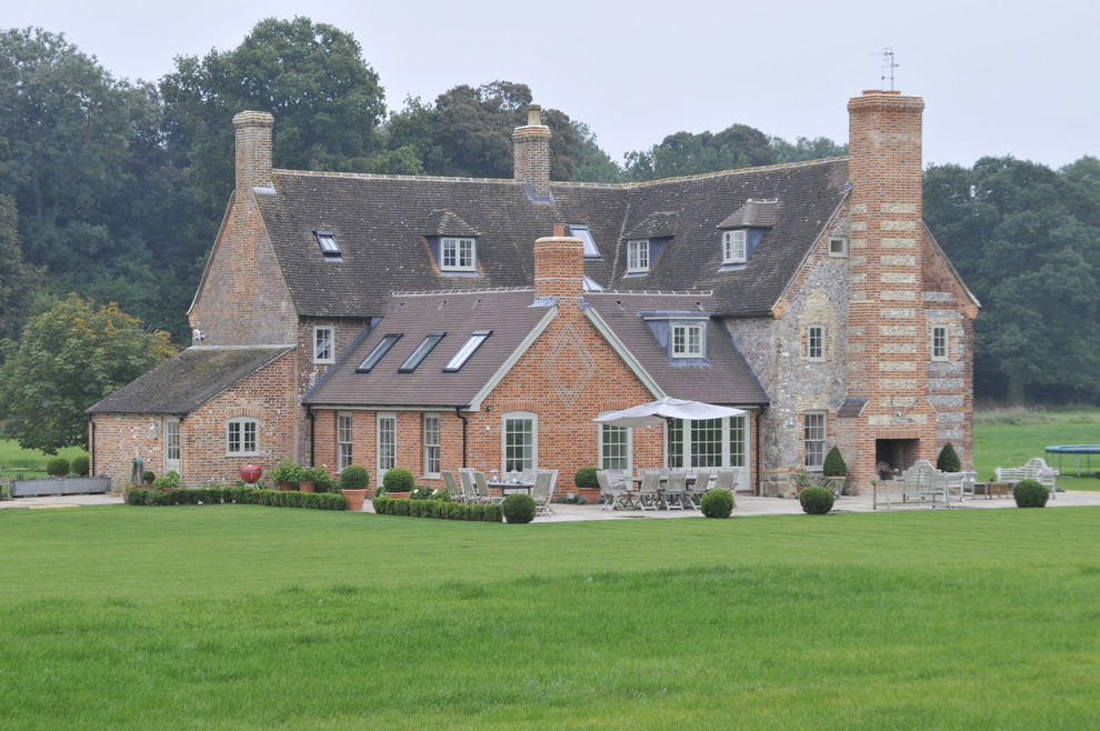 Inspiration for a large country brick house exterior in Wiltshire with three floors and a pitched roof.