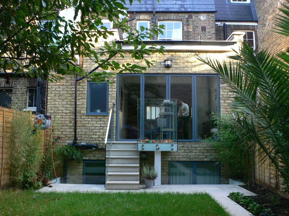 Inspiration for a small and beige contemporary two floor brick house exterior in Surrey with a flat roof.