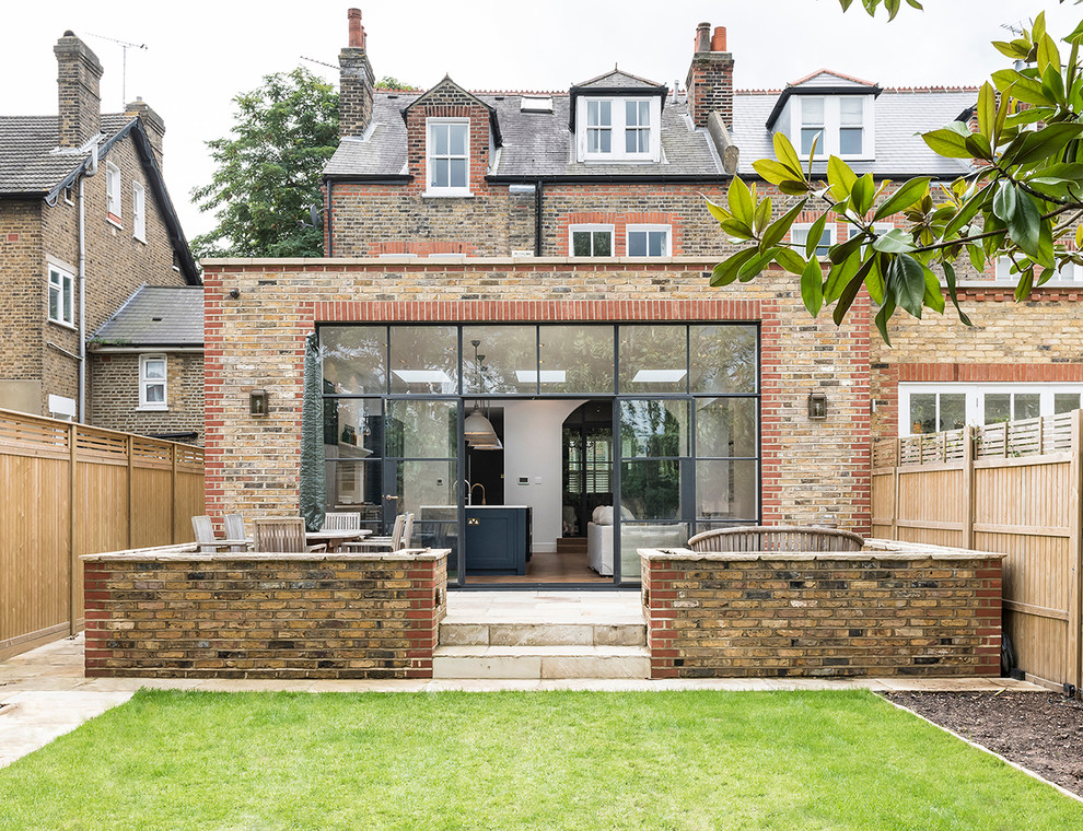 Large and beige traditional house exterior in London with three floors.