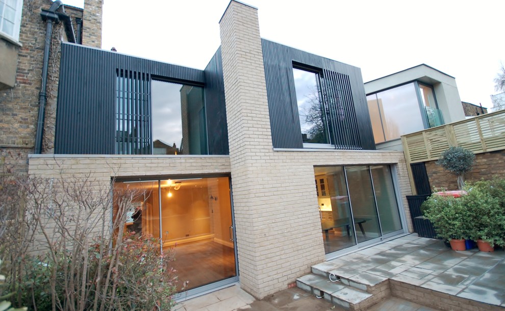 Large and gey contemporary house exterior in London with three floors and mixed cladding.