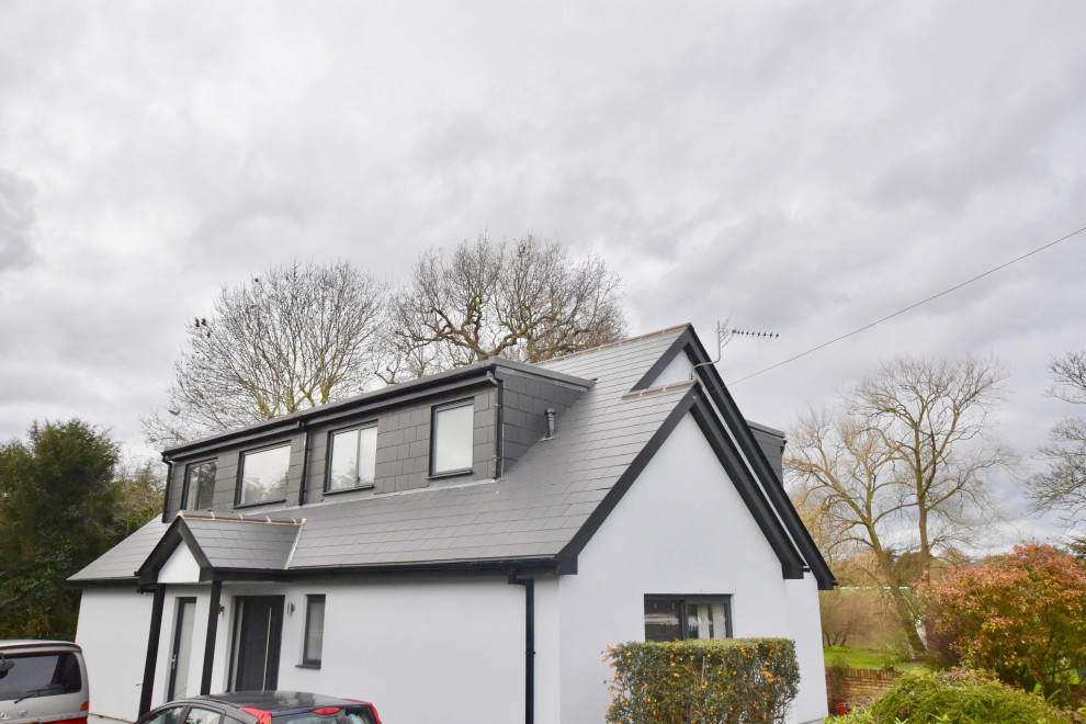 Photo of a modern two floor house exterior in Surrey with a tiled roof.