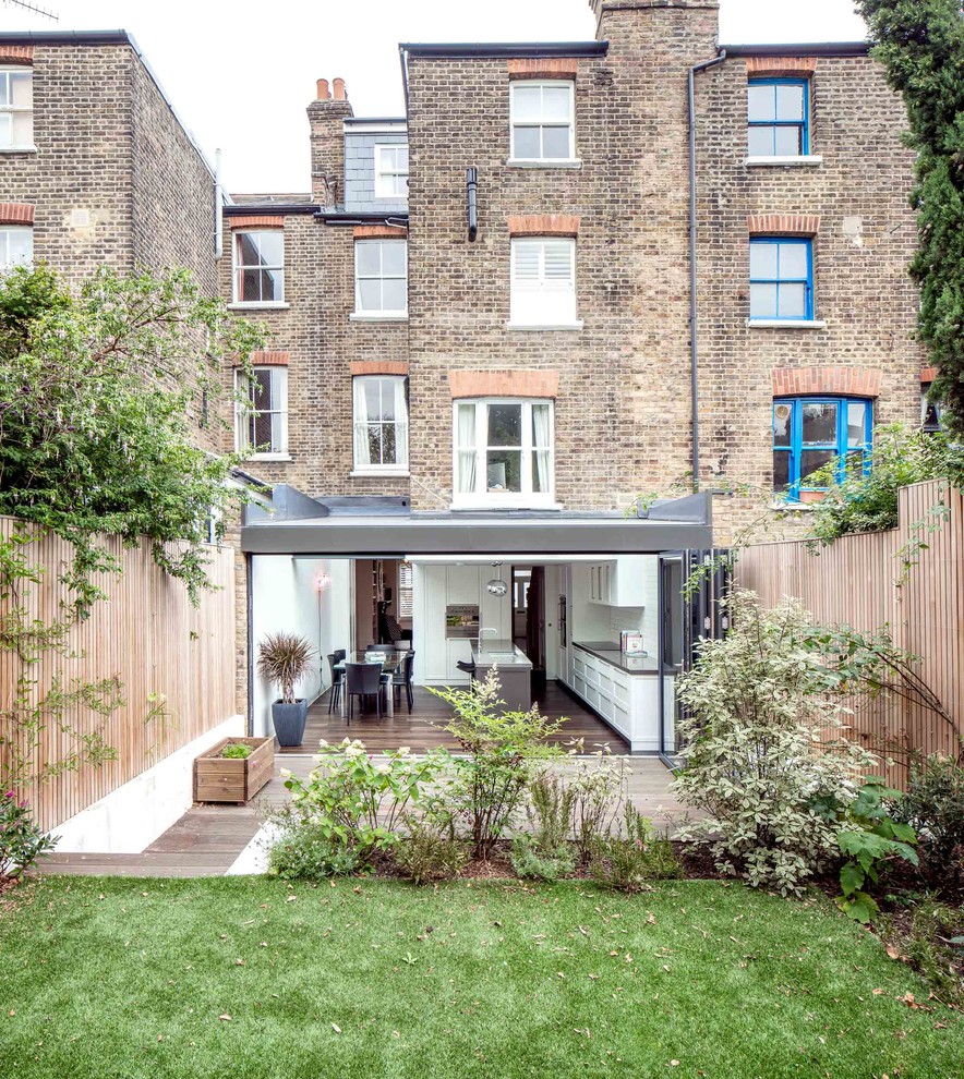 Inspiration for a medium sized contemporary brick and rear extension in London with three floors.