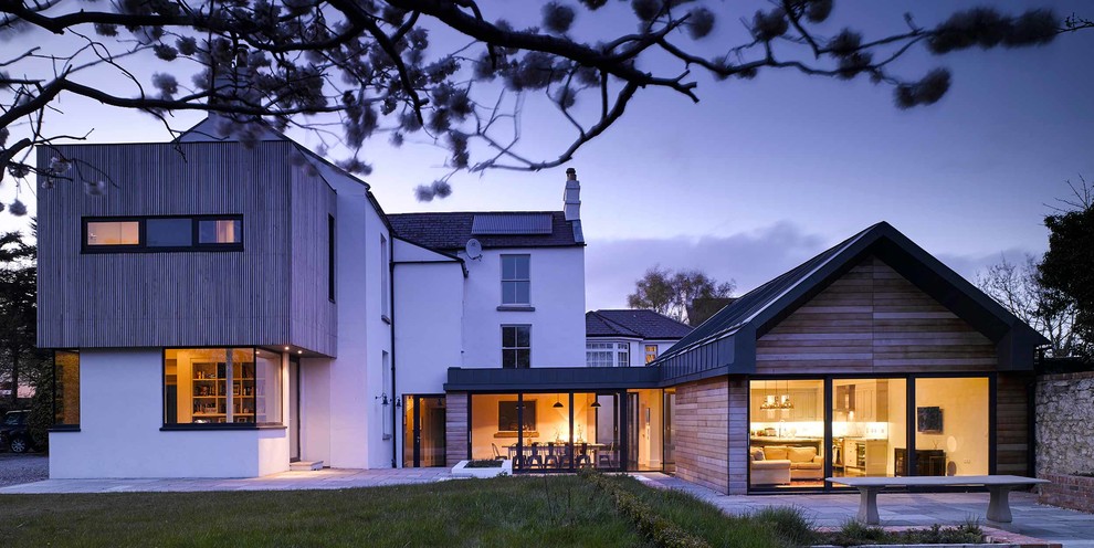Large contemporary house exterior in Dublin with mixed cladding.