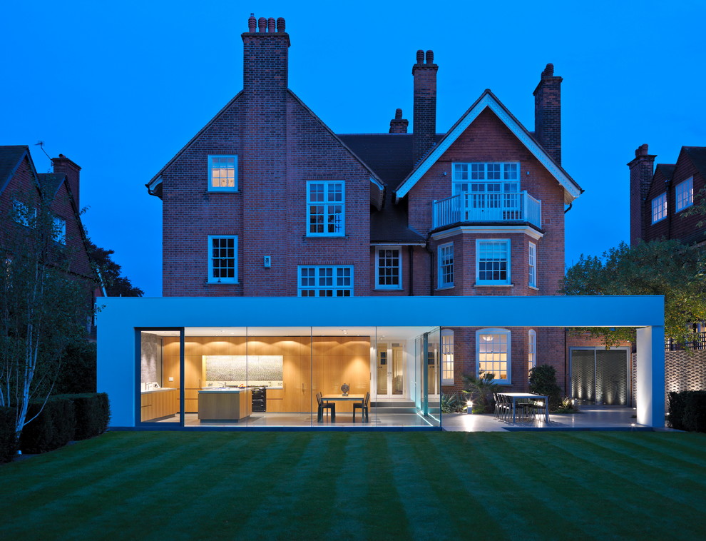 Inspiration for a modern brick house exterior in London with three floors.