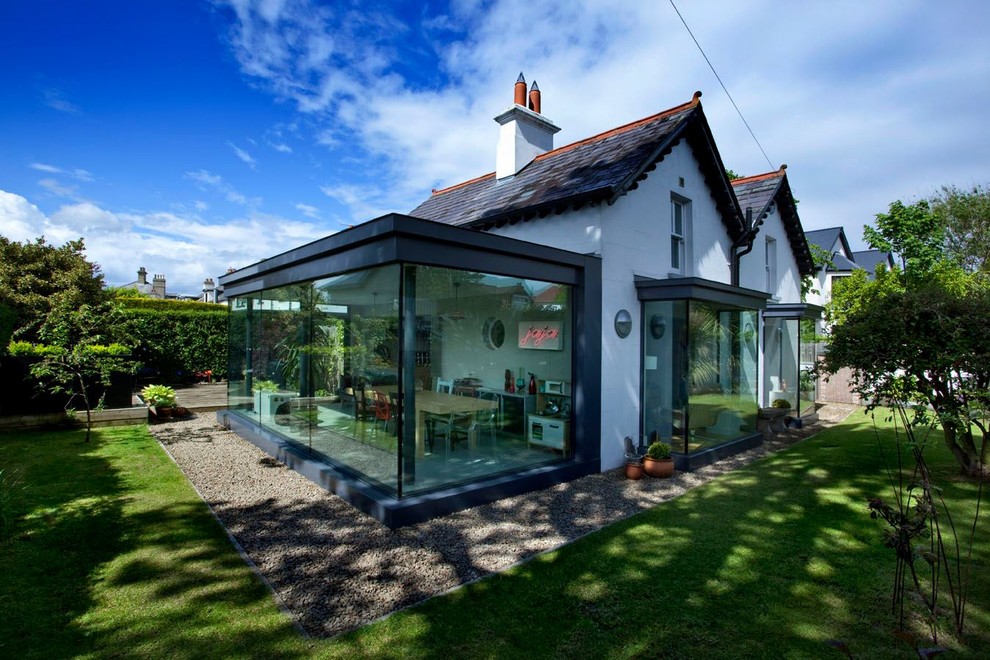 This is an example of a white contemporary two floor house exterior in Belfast.