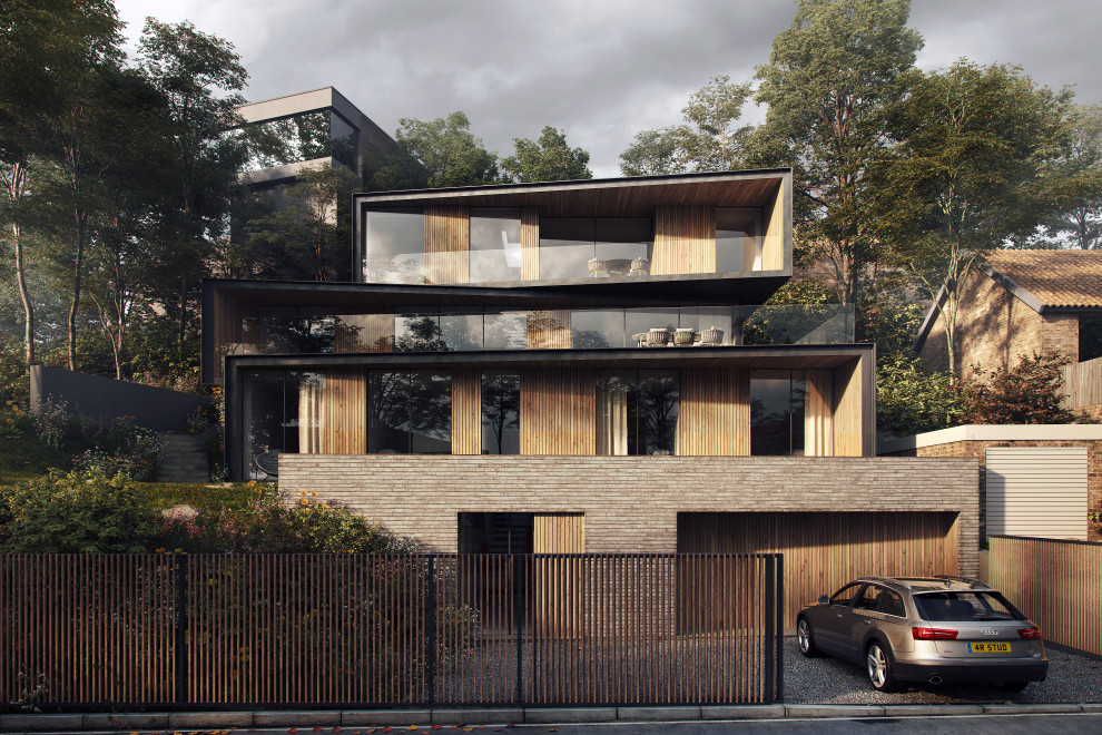 Bild på ett mellanstort funkis hus, med metallfasad och platt tak